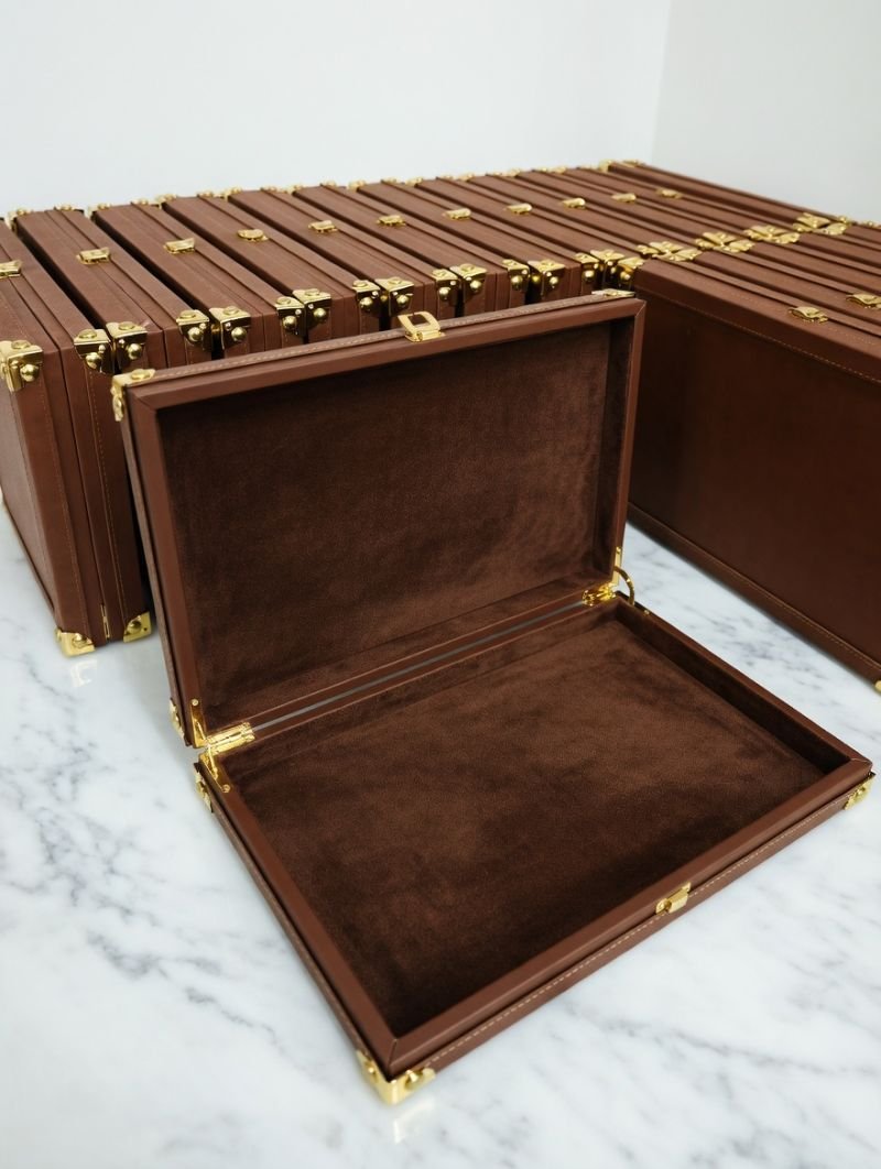 Tan timber and leather gift box shown open
