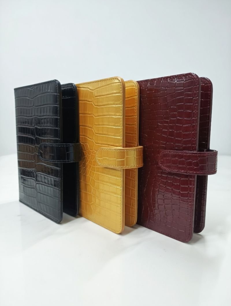 Croc-embossed black, yellow and burgundy leather diaries