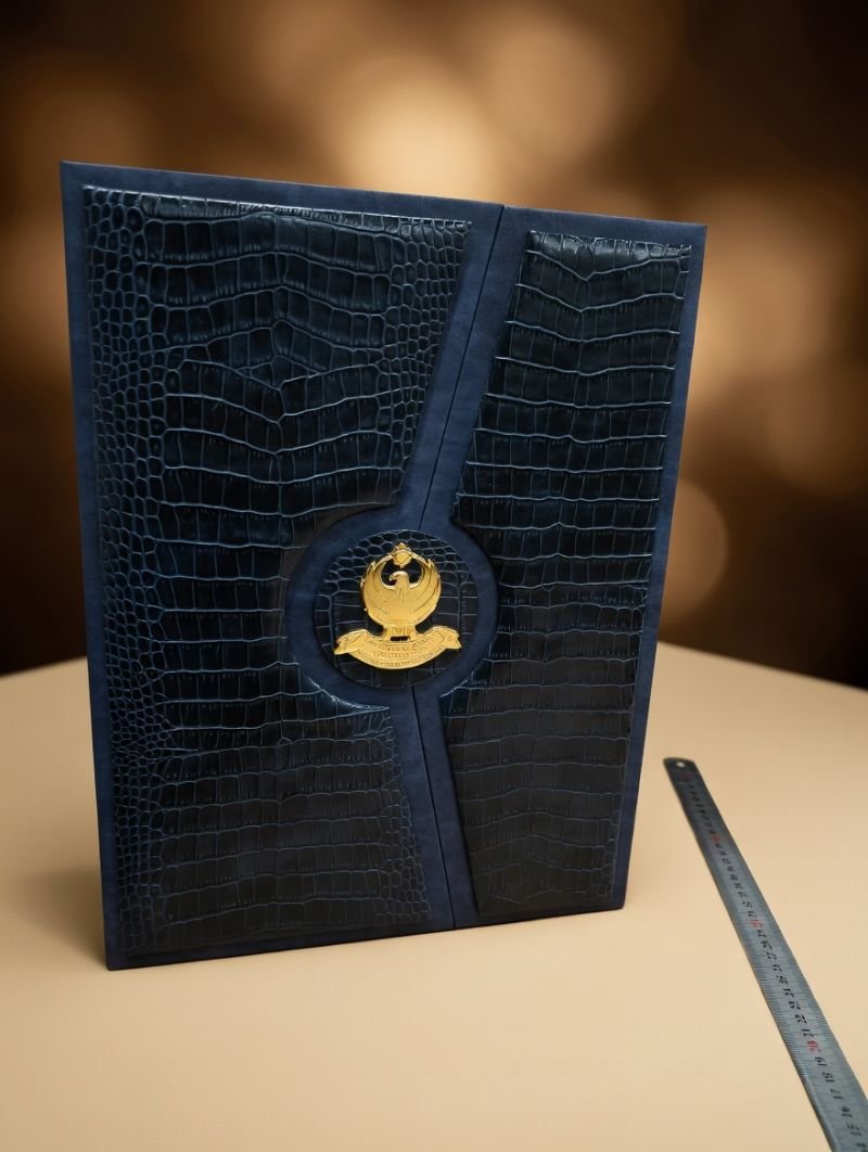 Navy croc-embossed leather portfolio folder with gold emblem