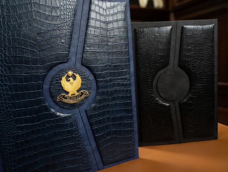 Navy and black emblem leather signature folders