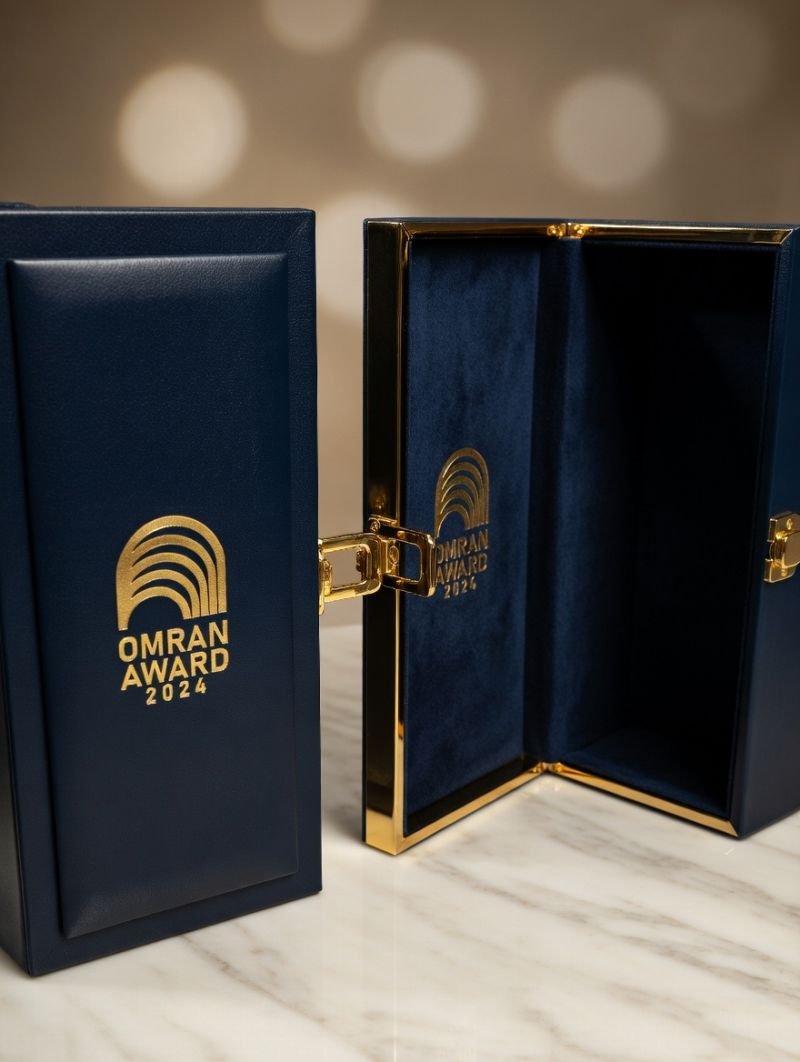Navy leather award box with gold emblem and twin lids